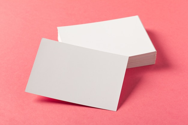 Blank paper pieces  on a colored pink background