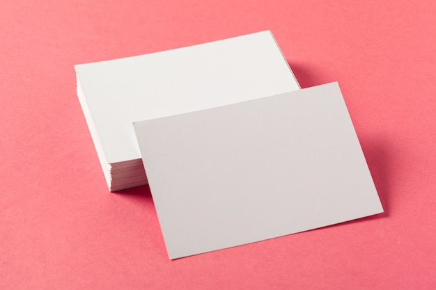 Blank paper pieces  on a colored pink surface