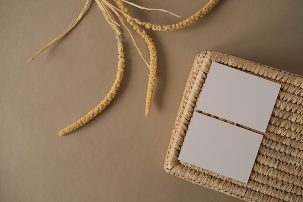 Blank paper sheet cards with dry plant branches rattan storage box