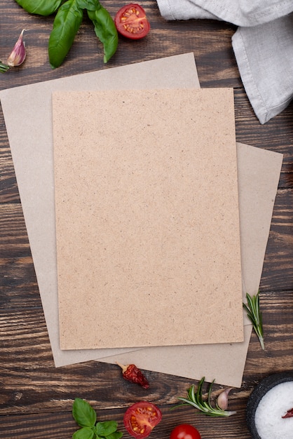 Blank paper sheet with cooking ingredients on table