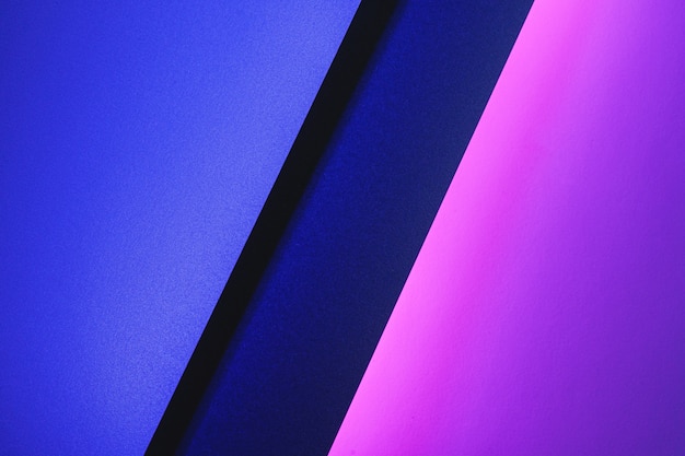 Blank paper sheets rolled in a neon purple lighting close up