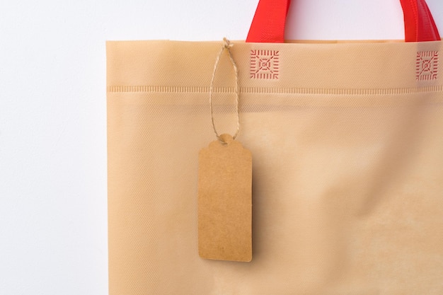 Blank paper tag with shopper paperbag on white background