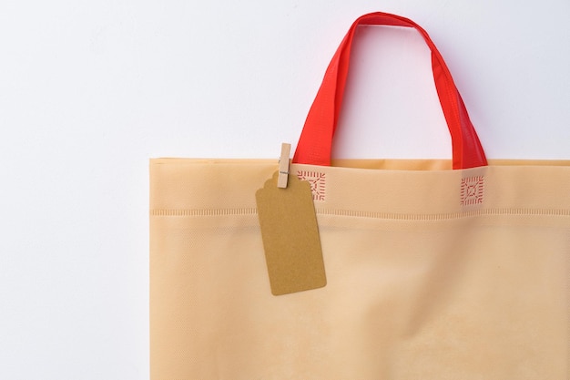 Blank paper tag with shopper paperbag on white background