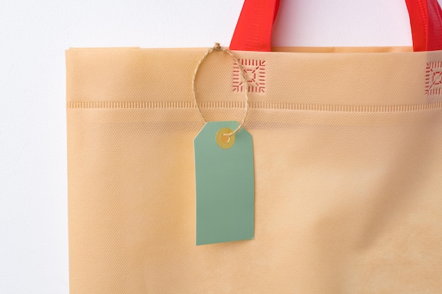 Blank paper tag with shopper paperbag on white background