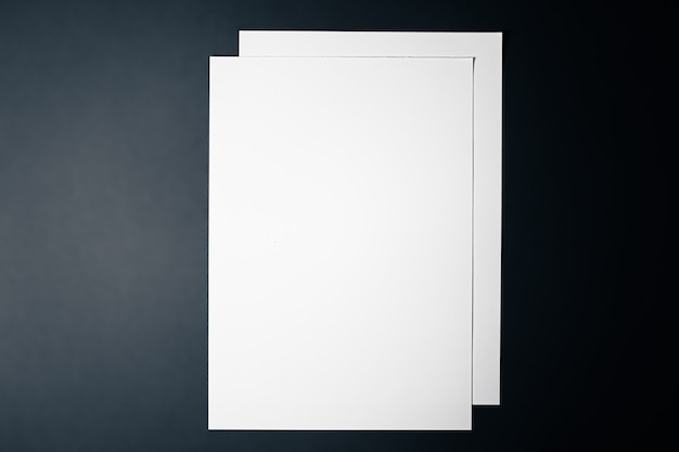 Photo blank a paper white on black background as office stationery flatlay luxury branding flat lay and br...