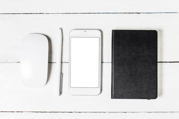 Blank paperwork template for designers. Responsive design mockup on vintage wooden background. Paper, letterhead, coffee cup, smartphone, pencil and headphones on wooden table background. Top view.