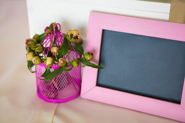 Blank photo frame and flowers bouquet