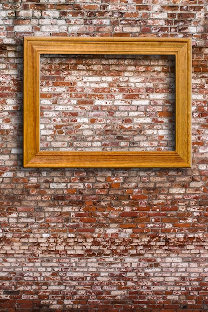 Blank photo frame on old brick wall