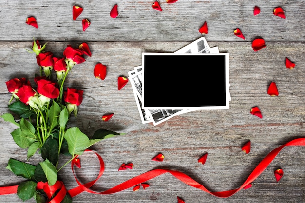 Photo blank photo frame and red roses flowers with petals