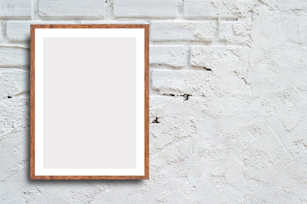 Blank picture frame on white brick wall