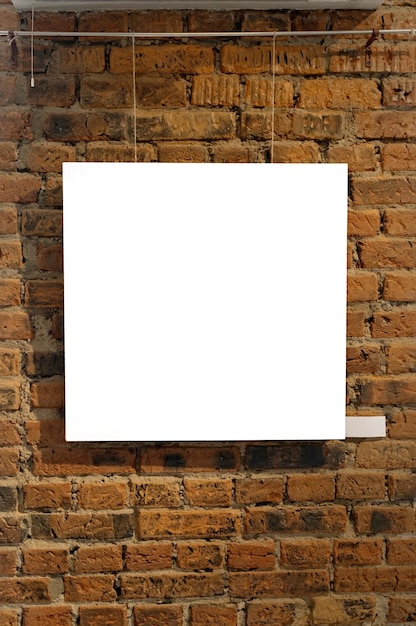 Photo blank picture frames on brick wall with glowing lamp in the gallery mock up