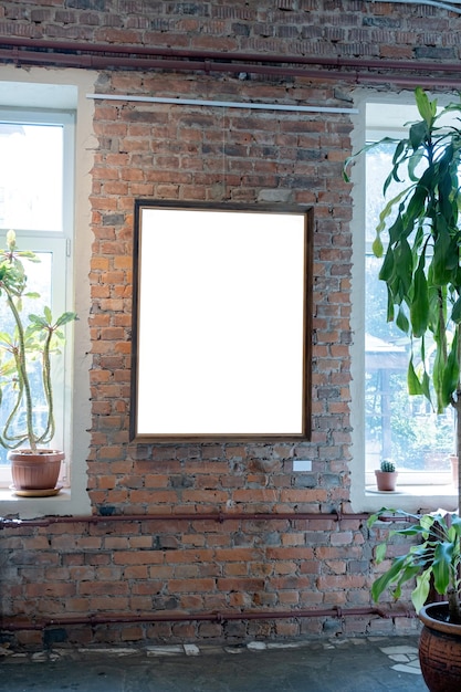 Photo blank picture frames on brick wall with glowing lamp in the gallery mock up