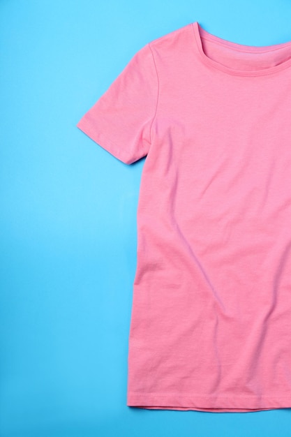 Blank pink t-shirt with space for print on blue background