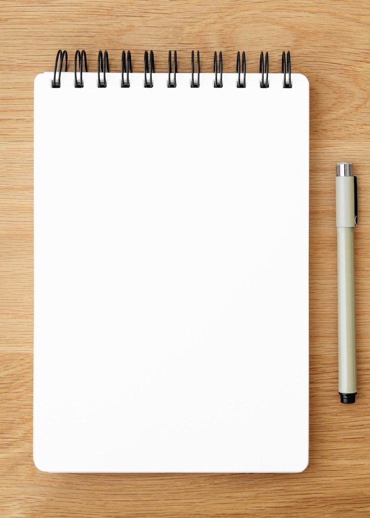 Photo blank plain white notebook page with a pen