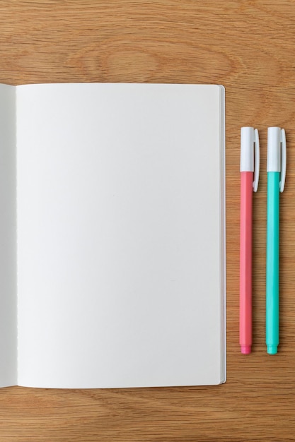 Blank plain white notebook page with a pen