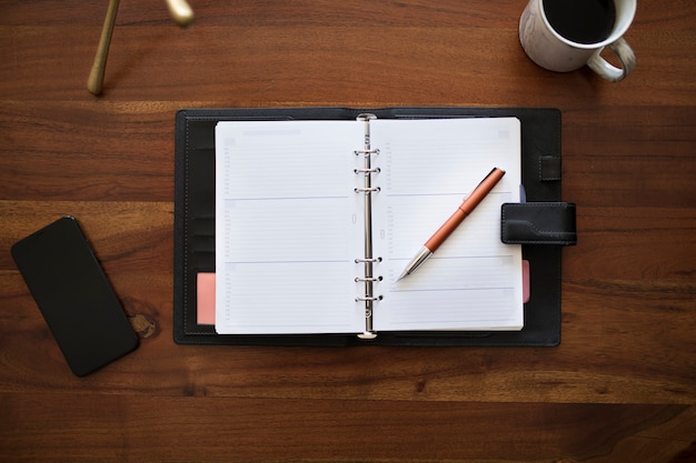 Blank planner on wooden desk