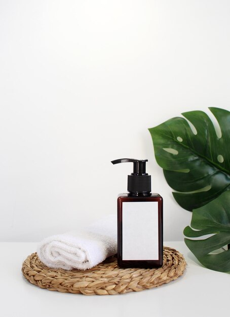 blank plastic cosmetics container for cream or shampoo cosmetics bottle mockup with tropical leaves beauty product design skincare and haircare concept