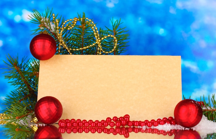 फोटो blank postcard, christmas balls and fir-tree on blue background