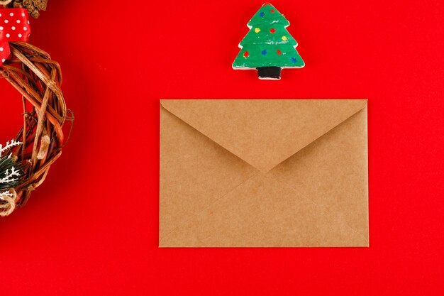 Photo blank postcard envelope and christmas decor on red background copy space