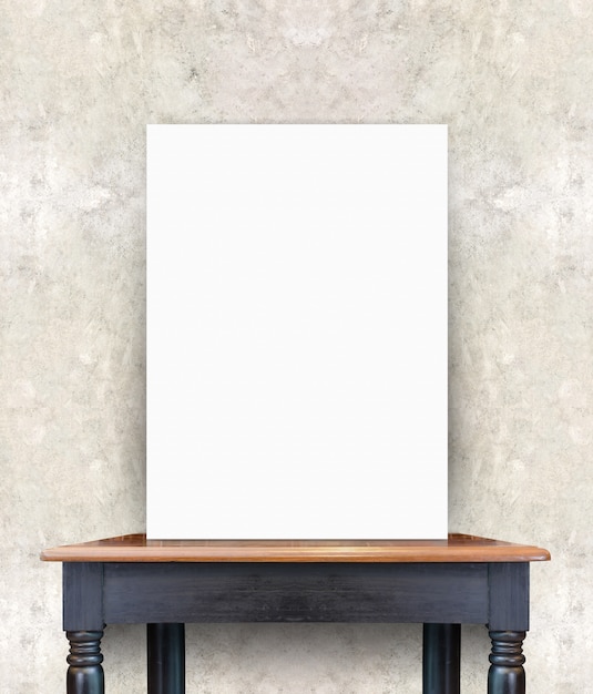 Photo blank poster on vintage wooden table at concrete wall,template for add your content