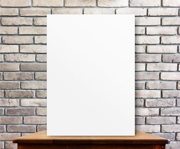 Photo blank poster on wood table at brick wall,perspective background