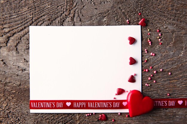 Blank present Valentine card on wooden background