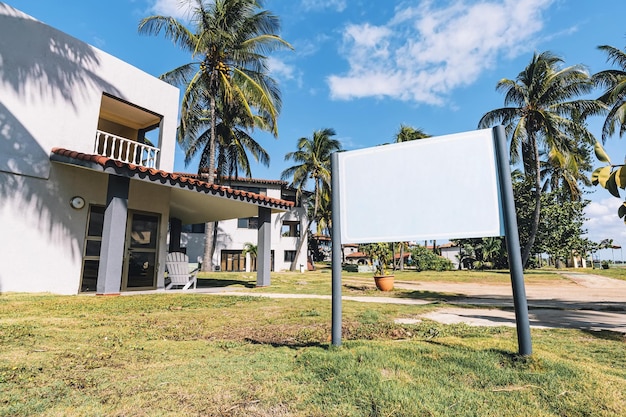 Blank Real Estate Sign in Front of Beautiful New House space for text or advertising