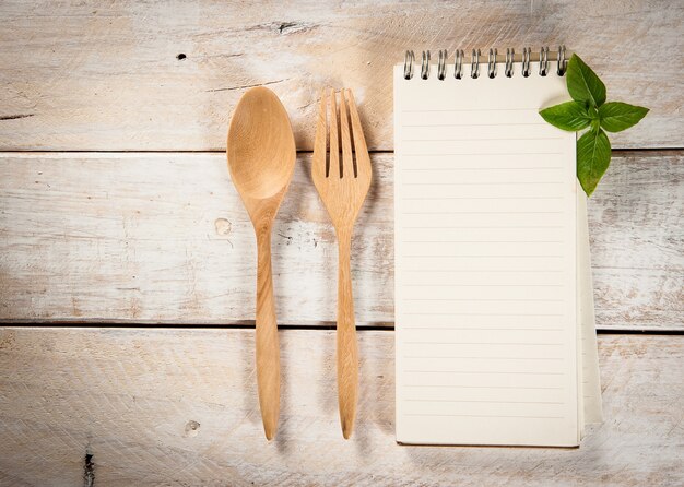 blank recipe book with wooden spoon