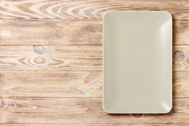 Blank rectangular plate on wooden. top view