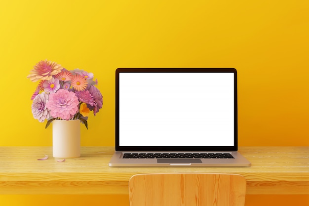 Blank screen computer Placed on a wooden table with trees and headphones in a yellow room