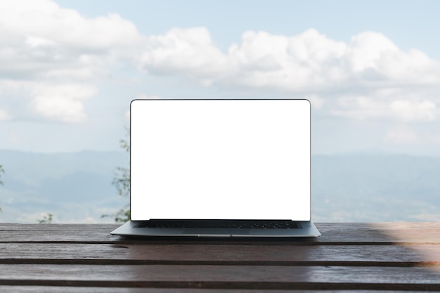 Blank screen laptop computer on background picturesque nature\
outdoor office travel concept business ideas choice of travel copy\
space online store technology digital cyberspace web network