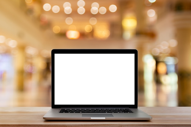 blank screen laptop computer on wooden table 