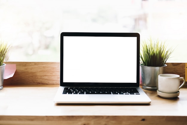 blank screen laptop on desk in office room 