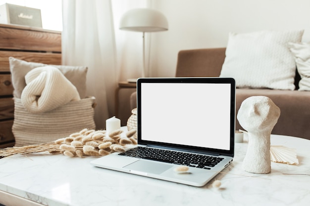 Blank screen laptop on marble table. Work at home concept for social media, website, blog.