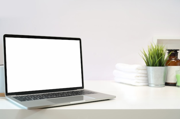 Blank screen laptop on spa table