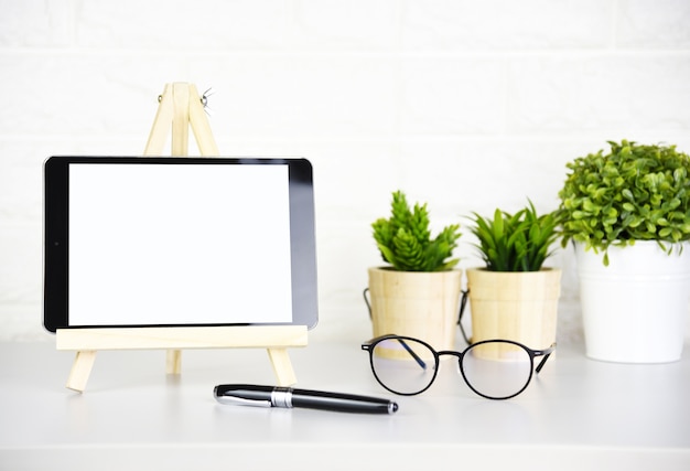 Photo blank screen tablet,glasses and pen on the modern table in office.