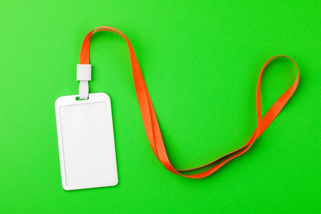 Blank security tag with a red stripe neck on a green background Place for text layout