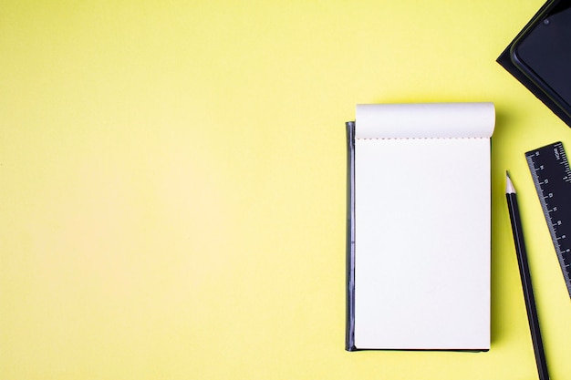 Blank sheet of notepad on yellow background