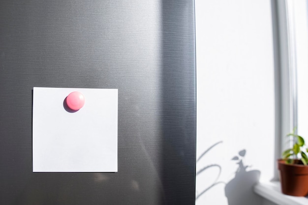 A blank sheet of paper attached with a magnet to the fridge