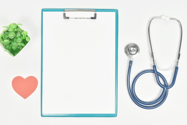 blank sheet of paper on clipboard with stethoscope and heart shape on the side