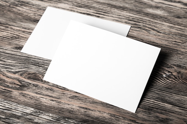 Blank sheets of paper on wooden background