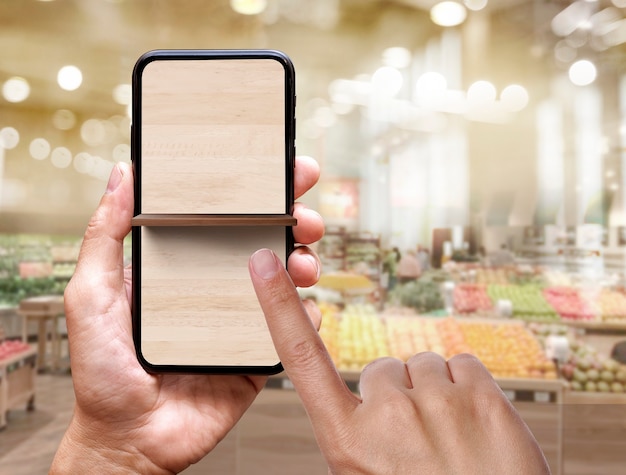 blank of shelf on mobile phone screen at supermarket