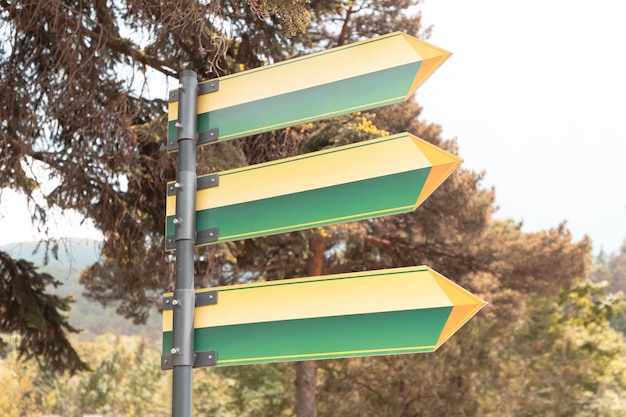 Blank sign pointer in natural park Empty arrow leading to destinations Hiking and trekking route into the wild