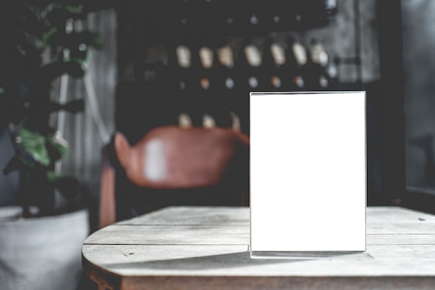 Blank sign on a wooden table in a cafe