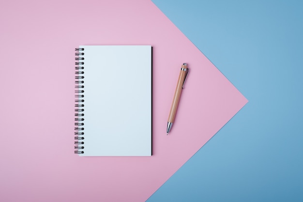 Blank spiral notebook on pastel background