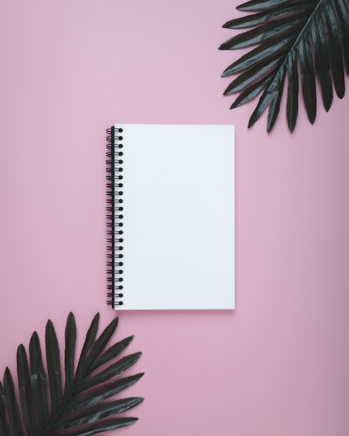 Blank spiral notebook on pastel.