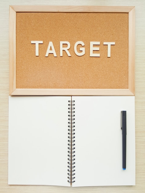 A blank spiral notebook with the reminder wooden board and pen 