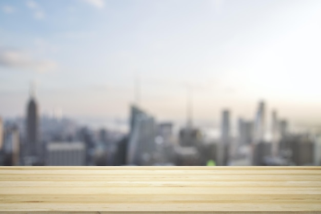 Blank table top made of wooden planks with beautiful blurry cityscape at daytime on background mockup