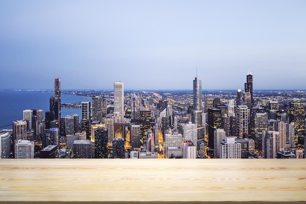 Blank table top made of wooden planks with beautiful Chicago cityscape at night on background mockup