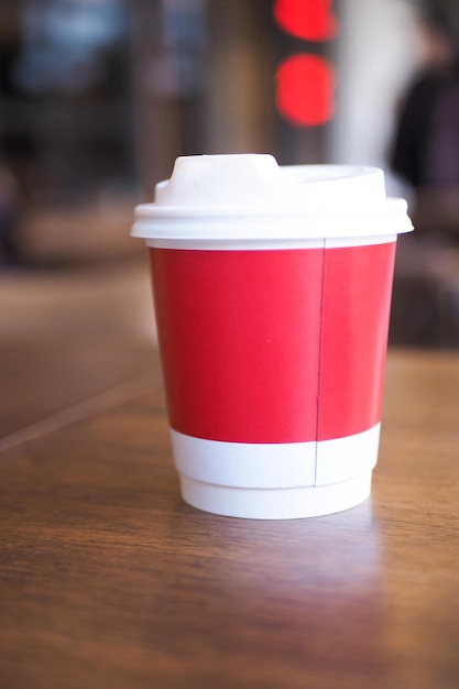 Blank take away kraft coffee cup on table